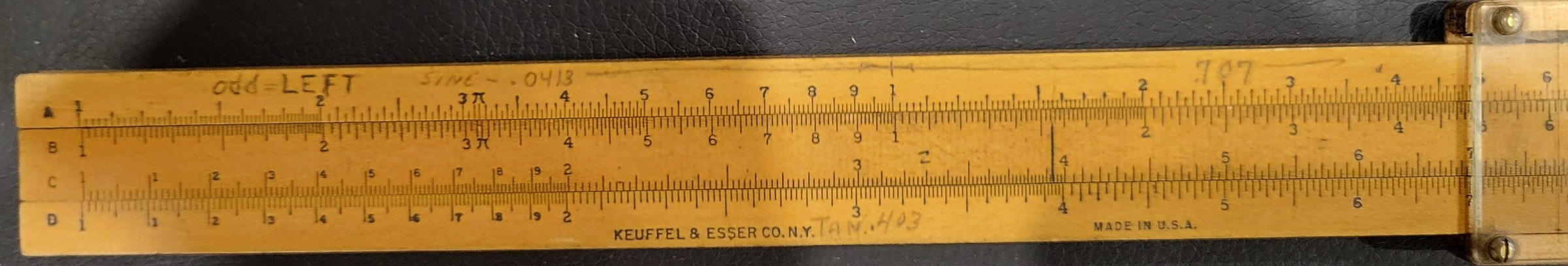 Figure 2 — The front of a K&E 4058C showing the A, B, C and D scales, the maker's name, and handwritten pencil notes including "odd = LEFT", "SINE - .0413", "707" and "TAN. 403".