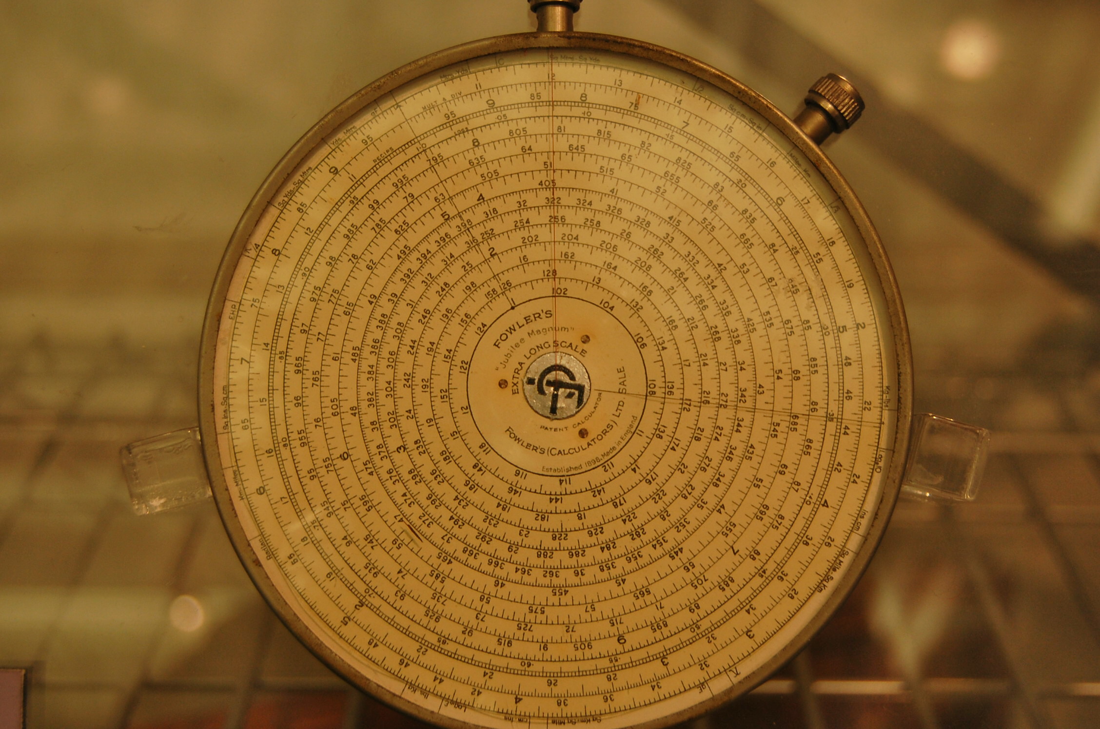 Figure 5 — Close view of a Fowler's Jubilee Magnum dial under glass, showing ten concentric circles of finely divided long scale and a centre marked "Fowler's 'Jubilee Magnum' Extra Long Scale, Fowler's (Calc…