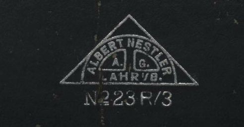 Figure 4 — The lid of a Nestler slide-rule case: a triangle enclosing "Albert Nestler A.G. Lahr i/B", above "No 23 R/3".
