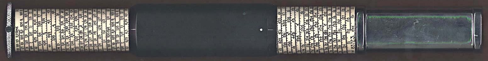 Figure 2 — A Model K Otis King photographed flat: knurled knob at left, cream helical cylinder scale, black cursor tube with a white dot near its right end, a short run of holder scale, and a clear-plated han…