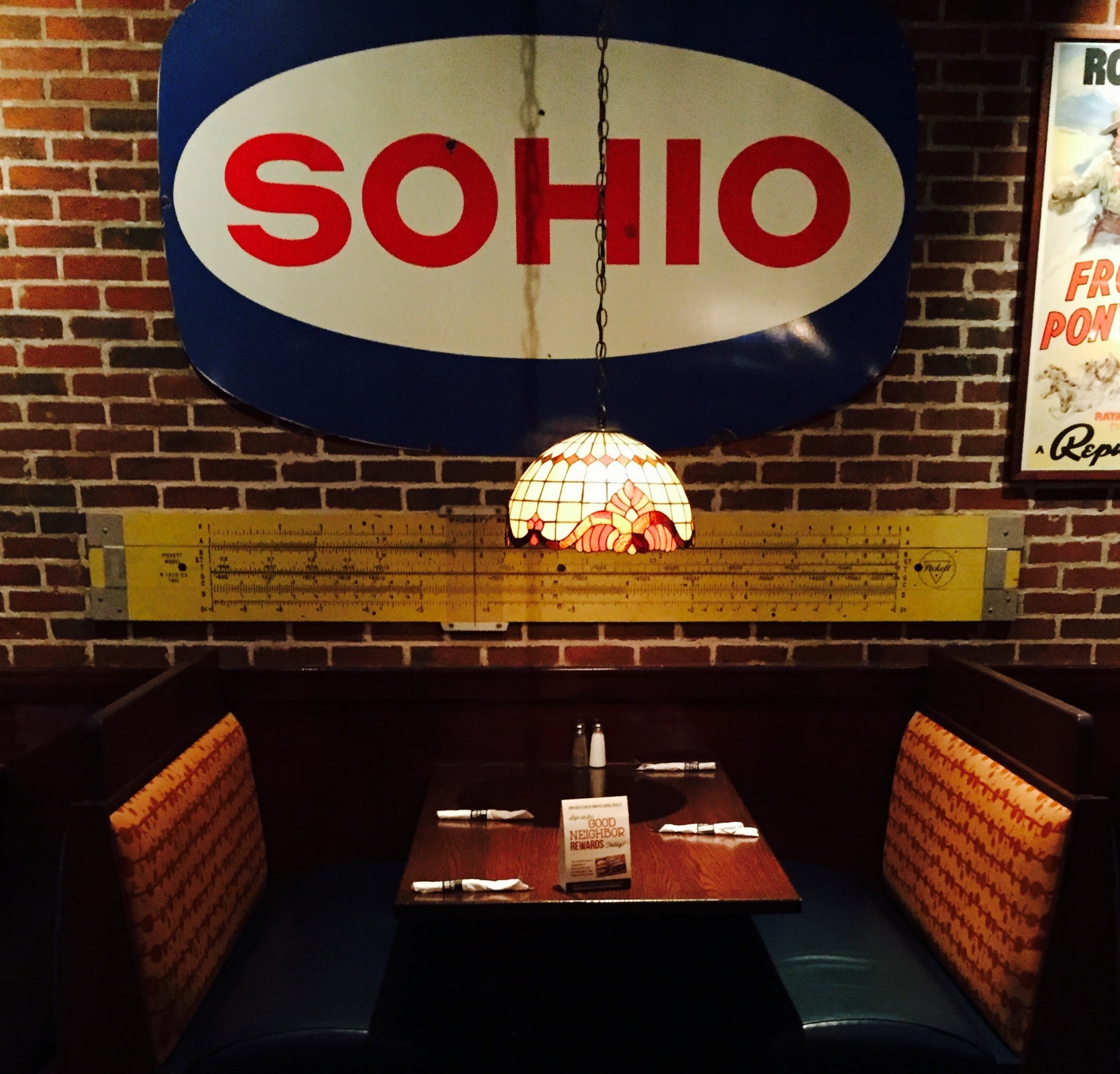 Figure 6 — A large yellow Pickett N1010-ES demonstration slide rule mounted high on the wall of a restaurant as decoration.