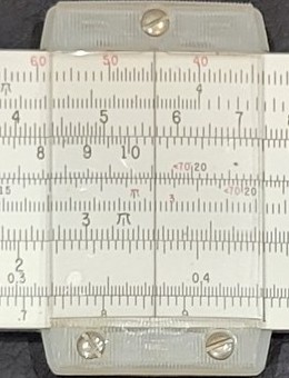 Figure 5 — Close view of the cursor of my N-515-T: a clear plastic lens with a single black hairline in a frame held by three slotted screws, over the scales.