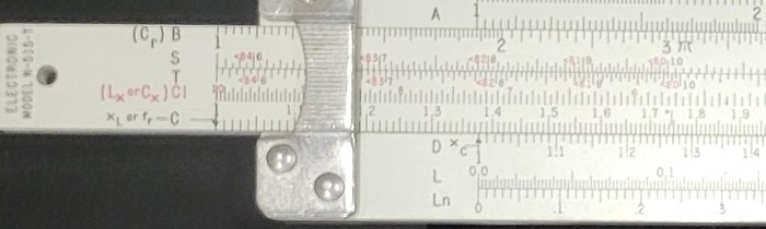 Figure 2 — Close view of the left end of my N-515-T: the slide end printed "ELECTRONIC MODEL N-515-T", the scale names (C r) B, S, T, (L x or C x) CI in red, and the X L or f r — C index arrow.