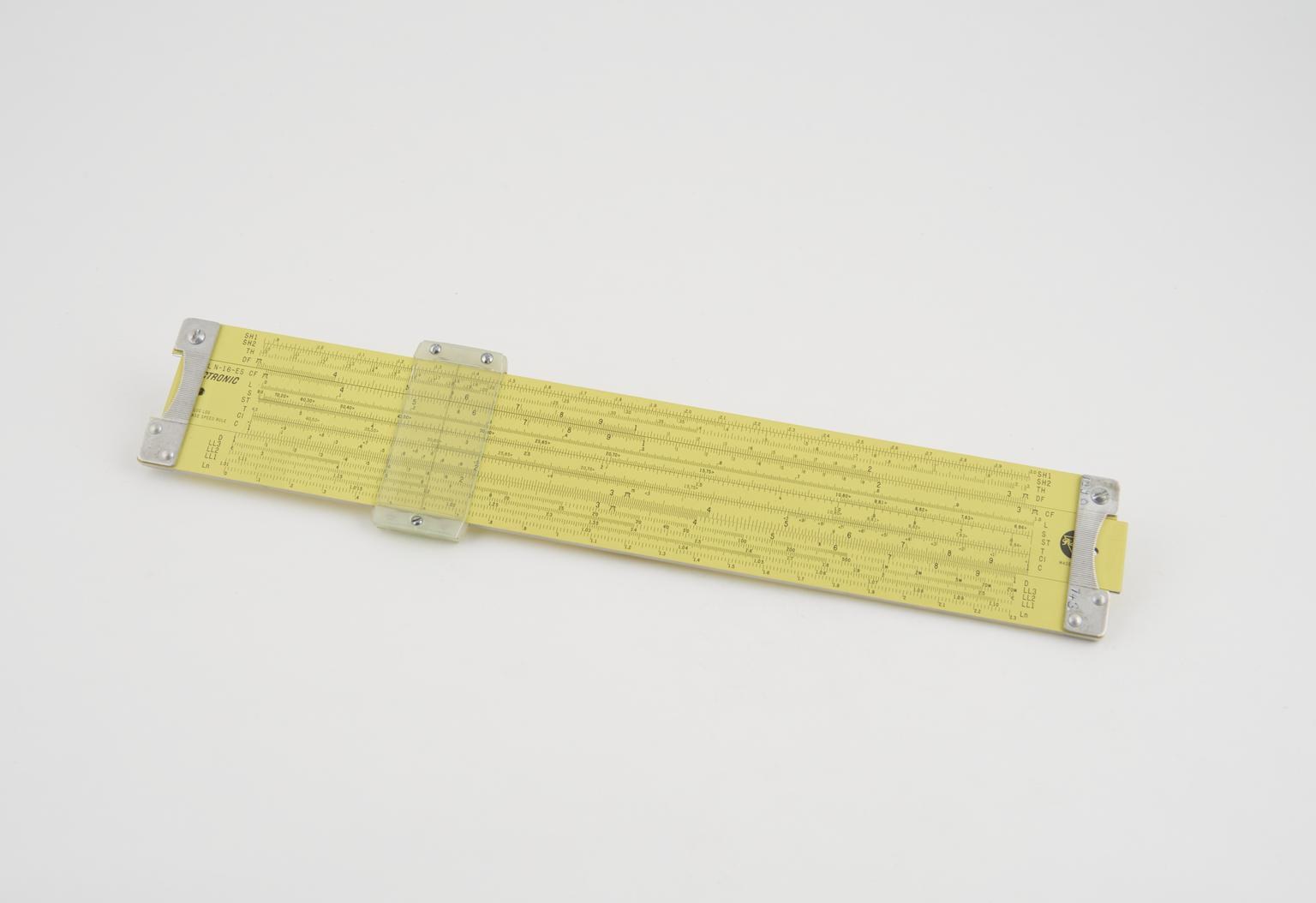 Figure 6 — A yellow Pickett N-16-ES Electronic slide rule photographed on a white background.